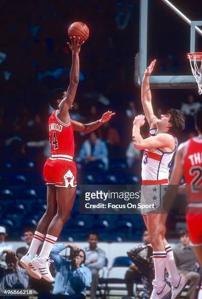 David Greenwood of the Chicago Bulls shoots over Jeff Ruland of the Washington Bullets during an NBA basketball game circa 1982 at the Capital Centre...