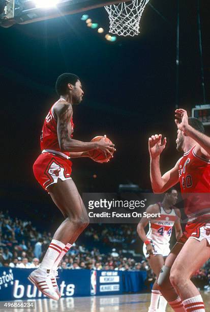 David Greenwood of the Chicago Bulls grabs a rebound against the Washington Bullets during an NBA basketball game circa 1982 at the Capital Centre in...