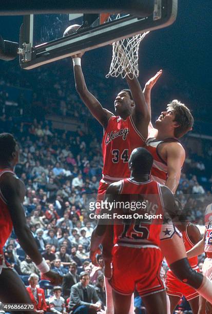 David Greenwood of the Chicago Bulls shoots over Jeff Ruland of the Washington Bullets during an NBA basketball game circa 1984 at the Capital Centre...