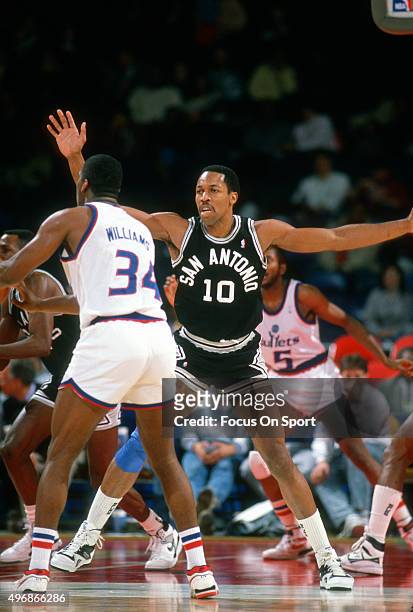David Greenwood of the San Antonio Spurs defends the pass of John Williams of the Washington Bullets during an NBA basketball game circa 1987 at the...