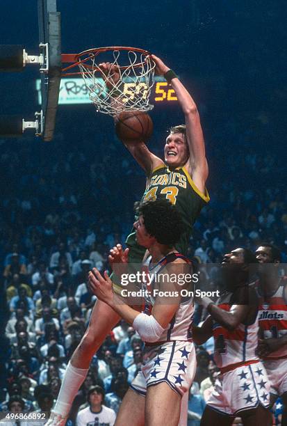 Jack Sikma of the Seattle Supersonics slam dunks the ball over Mitch Kupchak of the Washington Bullets during an NBA basketball game circa 1978 at...