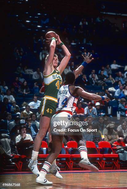 Jack Sikma of the Seattle Supersonics shoots over Rick Mahorn of the Washington Bullets during an NBA basketball game circa 1984 at the Capital...