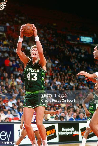 Jack Sikma of the Milwaukee Bucks grabs a rebound against the Washington Bullets during an NBA basketball game circa 1989 at the Capital Centre in...