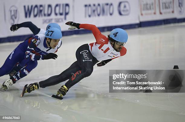 Charles Hamelin of Canada competes against Dmitry Migunov of Russia on Day 2 of the ISU World Cup Short Track Speed Skating competition at MasterCard...