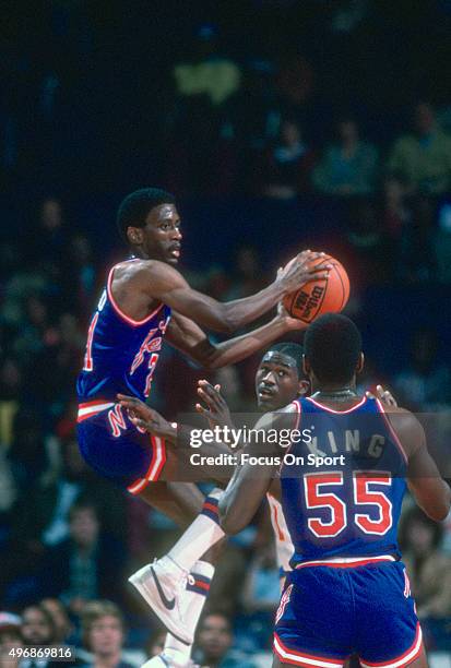 Sleepy Floyd of the New Jersey Nets looks to pass the ball over Dominique Wilkins of the Atlanta Hawks during an NBA basketball game circa 1982 at...