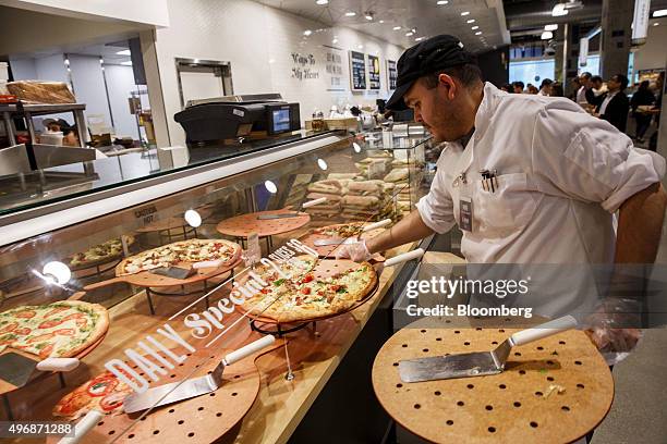 https://media.gettyimages.com/id/496871288/photo/an-employee-carries-a-pizza-to-the-prepared-food-section-of-the-new-whole-foods-market-inc.jpg?s=612x612&w=gi&k=20&c=YB4g8Eqml6vG4lMK0Zy64lG1FE31UHDUeyhIdDSR-0Y=
