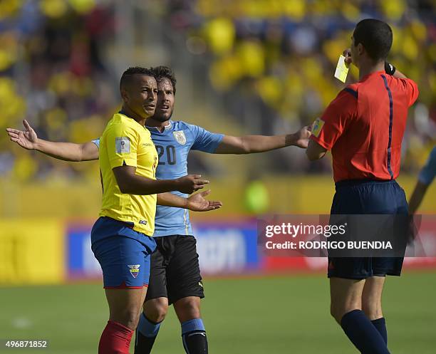 Brazilian referee Ricardo Marques Ribeiro shows a yellow card to Pedro Quinonez next to Uruguay's Alvaro Gonzalez during their Russia 2018 FIFA World...