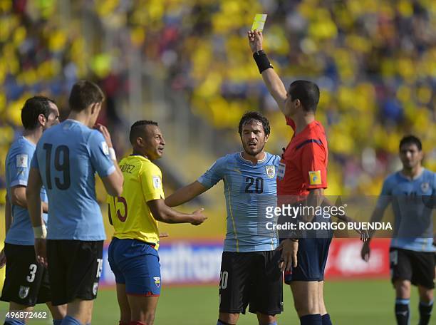 Brazilian referee Ricardo Marques Ribeiro shows a yellow card to Ecuador's Pedro Quinonez during their Russia 2018 FIFA World Cup South American...