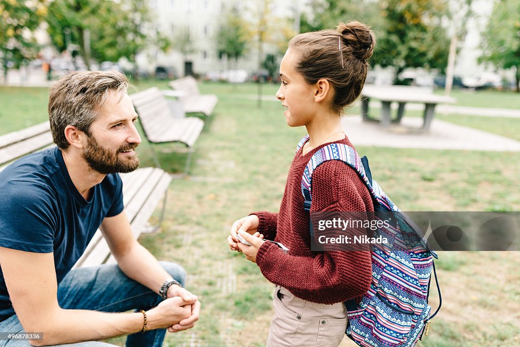 Father and daughters talking after school