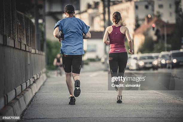 man and woman jogging - running coach stock pictures, royalty-free photos & images