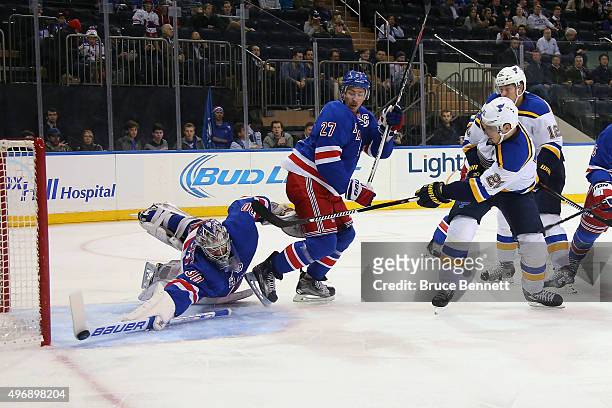 Henrik Lundqvist of the New York Rangers makes the first period stick save on Alexander Steen of the St. Louis Blues at Madison Square Garden on...