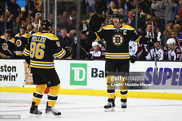 Zdeno Chara of the Boston Bruins celebrates with Kevan Miller after scoring a goal against the Colorado Avalanche during the first period at TD...