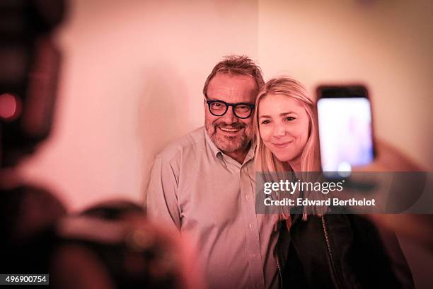 Oliviero Toscani posing with a guest at his own Exhibition At La Hune on November 12, 2015 in Paris, France.