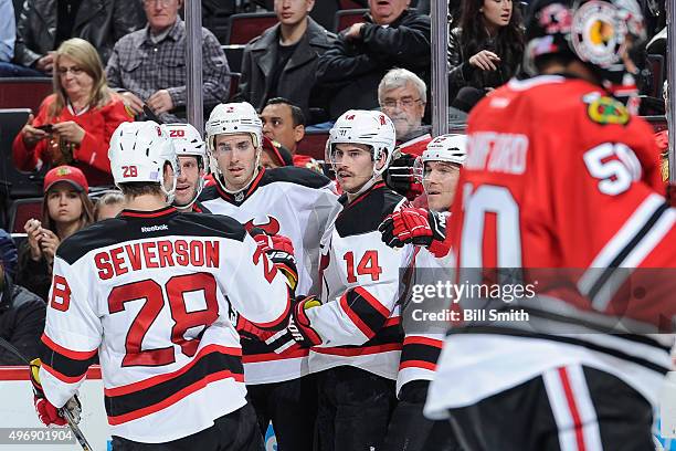 Adam Henrique of the New Jersey Devils celebrates with teammates, including Lee Stempniak, John Moore and Mike Cammalleri, after scoring in the...