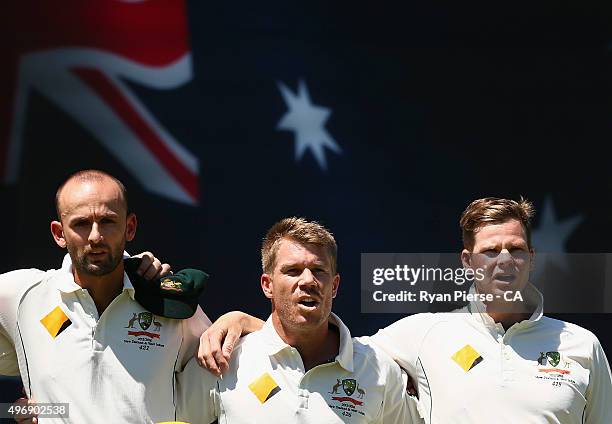 Nathan Lyon, David Warner and Steve Smith of Australia sing the national anthem during day one of the second Test match between Australia and New...