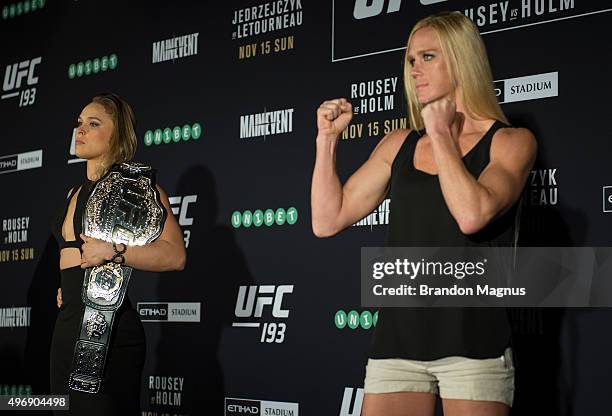 Women's bantamweight champion Ronda Rousey of the United States and Holly Holm of the United States pose for a photo during the UFC 193 Ultimate...