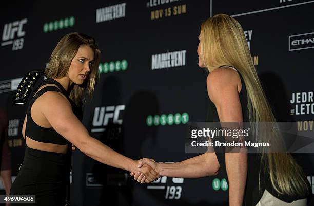 Women's bantamweight champion Ronda Rousey of the United States shakes hands with Holly Holm of the United States during the UFC 193 Ultimate Media...