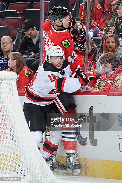 Brian O'Neill of the New Jersey Devils checks Viktor Svedberg of the Chicago Blackhawks into the boards in the second period of the NHL game at the...
