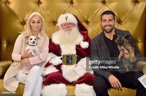 Hollywood couple Jesse Metcalfe, Cara Santana and their pups Shepherd and Dexter pose for the first 'Pet Portrait with Santa' of the season at the...