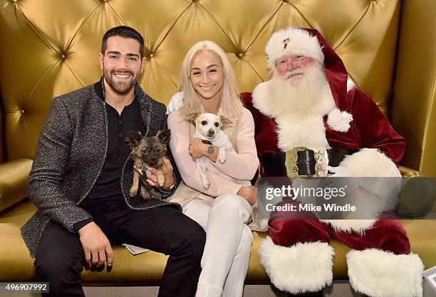 Hollywood couple Jesse Metcalfe, Cara Santana and their pups Shepherd and Dexter pose for the first 'Pet Portrait with Santa' of the season at the...