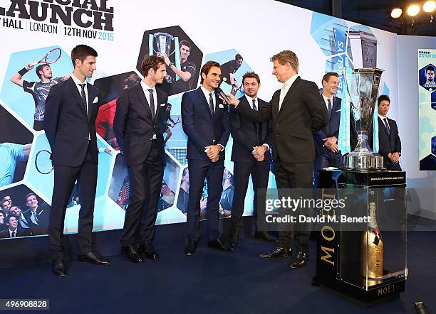 Novak Djokovic, Andy Murray, Roger Federer, Stan Wawrinka, Andrew Castle Tomas Berdych and Kei Nishikori celebrate with Moet & Chandon and raise a...