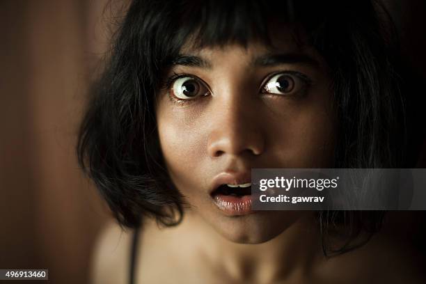 eyes and mouth widely open of surprised teenage asian girl. - kid facial expression stock pictures, royalty-free photos & images