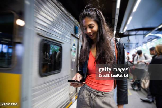 woman commuting in a sydney train and texting - sydney train stock pictures, royalty-free photos & images