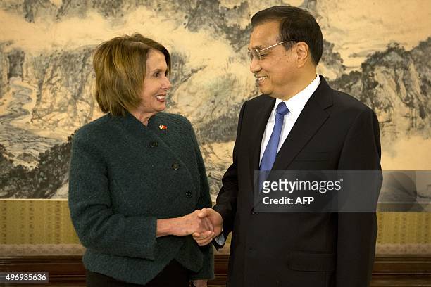 House Minority Leader Nancy Pelosi of California shakes hands with Chinese Premier Li Keqiang as she arrives for a bilateral meeting at the...