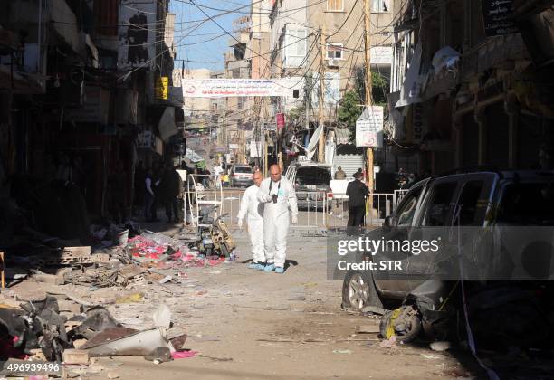 Lebanese forensic police investigate the site of a twin bombing attack that rocked a busy shopping street in the area of Burj al-Barajneh, a Beirut...