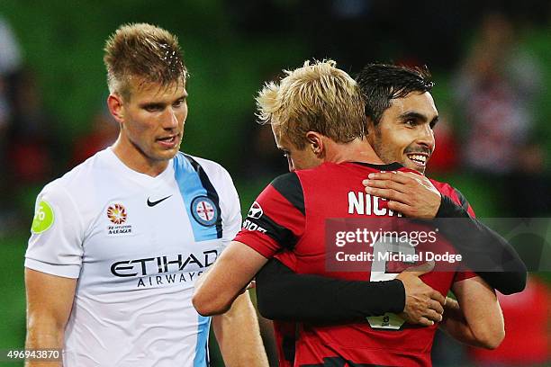 Mitch Nichols of the Wanderers and Dimas Delgado celebrate the win next to Erik Paartalu of Melbourne City during the round six A-League match...