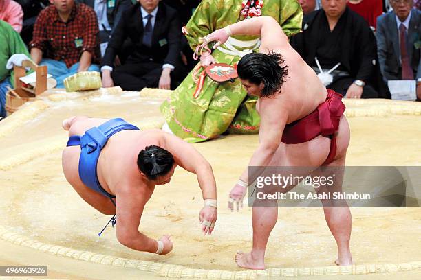 Mitakeumi throws Mongolian wrestler Tamawashi to win during day six of the Grand Sumo Kyushu Tournament at Fukuoka Convention Center on November 13,...