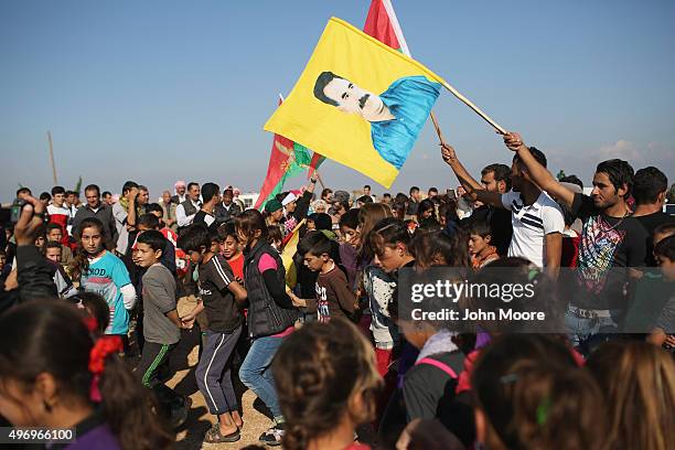 Yazidi refugees celebrate news of the liberation of their homeland of Sinjar from ISIL extremists, while at a refugee camp on November 13, 2015 in...