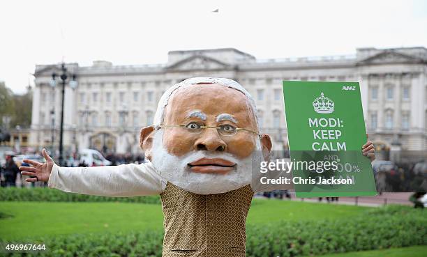 Protestors from AVAAZ hold up banners outside Buckingham Palace on November 13, 2015 in London, England. AVAAZ, one of the worlds largest online...