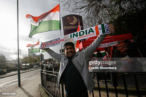 Pedestrian holds a scarf commemorating the visit of Narendra Modi, India's prime minister, to the U.K. As he arrives to attend a community reception...