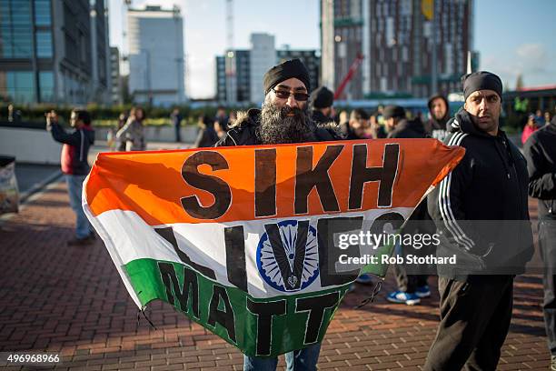 Sikh protester holds a flag of India and stands outside Wembley Stadium as crowds arrive to hear Indian Prime Minister Narendra Modi speak during the...