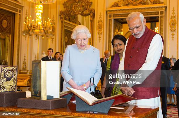 Queen Elizabeth II and Indian Prime Minister Narendra Modi view items from the Royal Collection at Buckingham Palace on the second day of his visit...