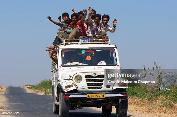 Unidentified travellers, mostly salt workers in the Little Rann of Kutch near Dhrangadhra, Gujarat, India. Transport for workers is often overcrowded.