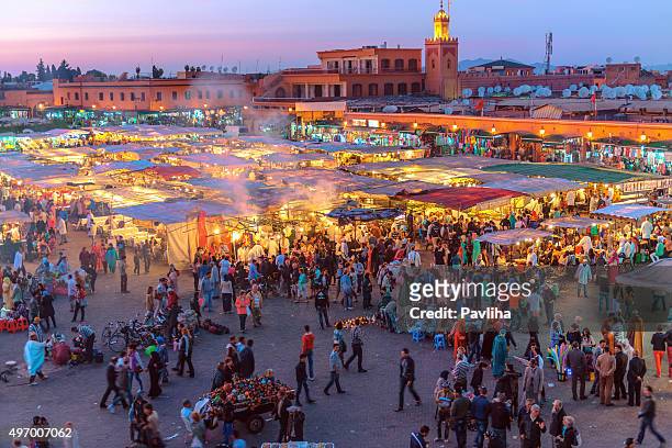 evening djemaa el fna square with koutoubia mosque, marrakech, morocco - twilight market stock pictures, royalty-free photos & images