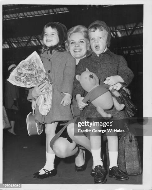 Actress Carroll Baker with her children Blanche and Herschel at Waterloo Station, London, May 8th 1962.