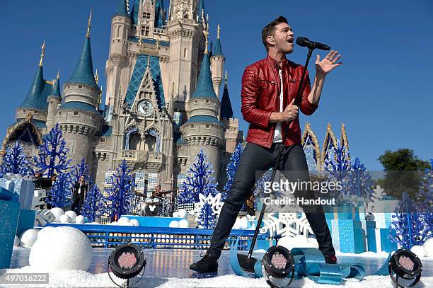 In this handout provided by Disney Parks, Andy Grammer performs during the taping of the 'Disney Parks Unforgettable Christmas Celebration' TV...