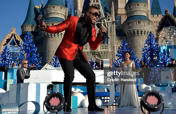 In this handout provided by Disney Parks, Charles Perry and Jhené Aiko perform during the taping of the 'Disney Parks Unforgettable Christmas...