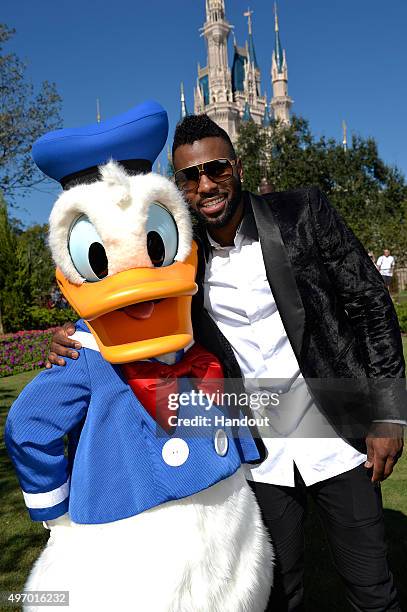 In this handout provided by Disney Parks, Jason Derulo poses with Donald Duck during a break from taping the 'Disney Parks Unforgettable Christmas...