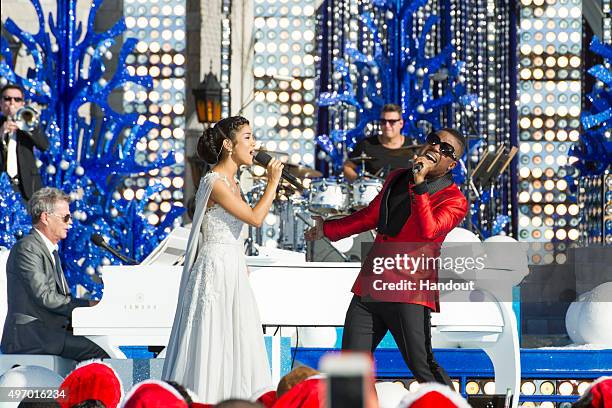 In this handout provided by Disney Parks, Charles Perry and Jhené Aiko perform during the taping of the 'Disney Parks Unforgettable Christmas...