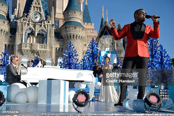 In this handout provided by Disney Parks, Charles Perry and Jhené Aiko perform during the taping of the 'Disney Parks Unforgettable Christmas...
