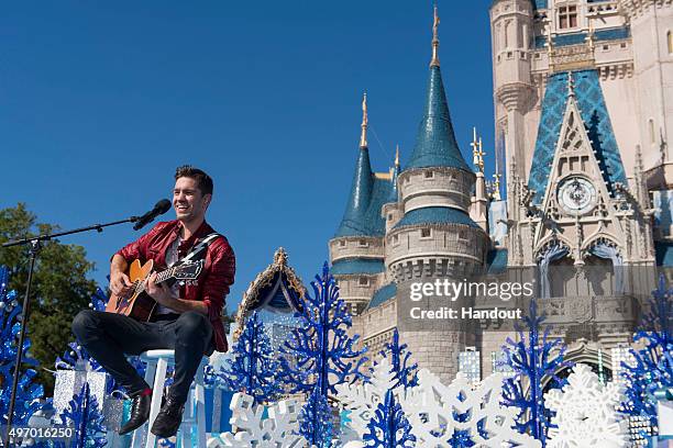 In this handout provided by Disney Parks, Andy Grammer performs during the taping of the 'Disney Parks Unforgettable Christmas Celebration' TV...