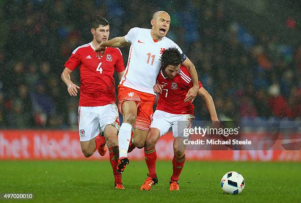 Joe Allen of Wales is challenged by Arjen Robben of Netherlands during the international friendly match between Wales and Netherlands at Cardiff City...