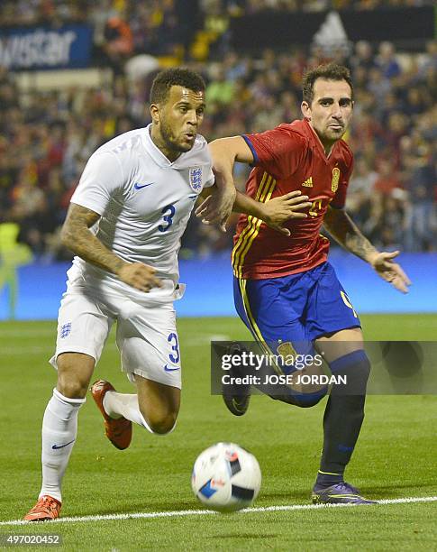 England's defender Ryan Bertrand vies with Spain's forward Paco Alcacer during the friendly football match Spain vs England at the Jose Rico Perez...