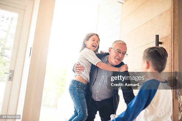 grandpa is here! - arrival hug stock pictures, royalty-free photos & images