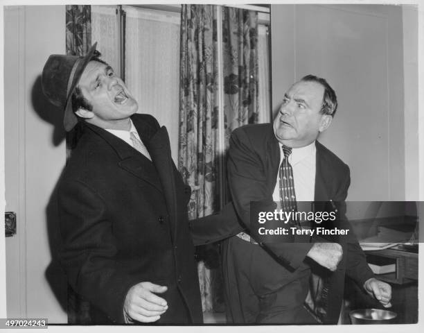 Actor Pat O'Brien and boxer Freddie Mills, larking around as they make the film 'Kill Me Tomorrow', September 28th 1956.