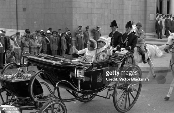 King Constantine of Greece and Princess Anne Marie of Denmark, waving to crowds from a carriage following their wedding, September 18th 1964.